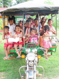 Children in Cambodia witting in a motorcycle carriage