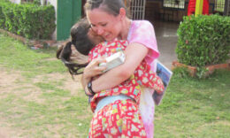 Student hugging a child during a Mercer On Mission trip
