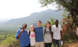 Mercer students standing outside with locals in Kenya
