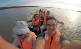 Mercer students riding a boat down a river