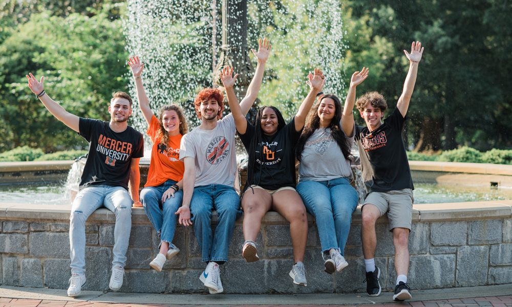Mercer students sitting near the fountain in Tattnall Square Park