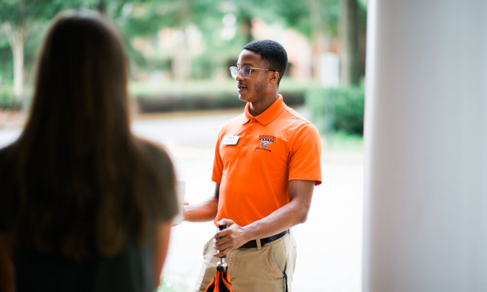 Student admissions worker leading a tour