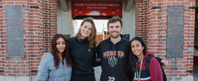 Students standing outside Luther Williams Field