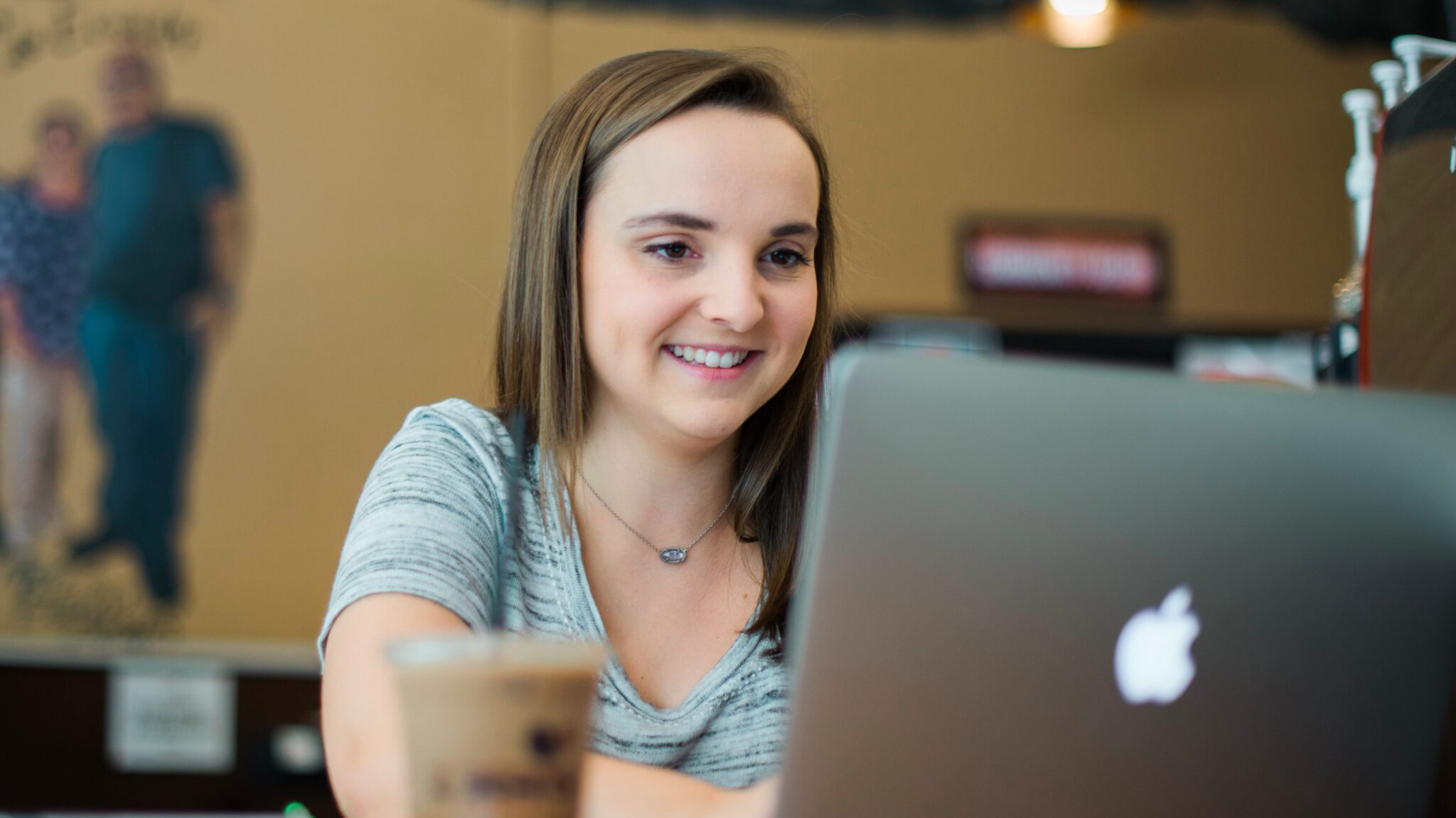 Student working on a laptop in a coffee shop