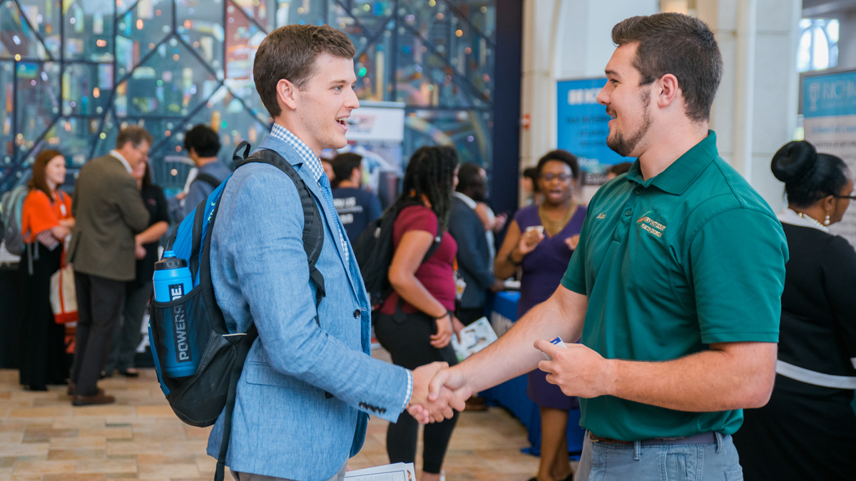 Student shaking a recruiter's hand at a career fair
