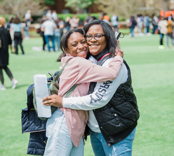 Mother and daughter posing for a photo