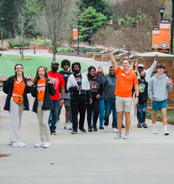 Admissions student workers walking with prospective students