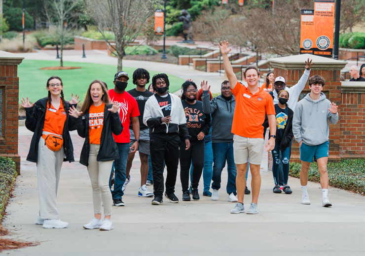 Admissions student workers walking with prospective students