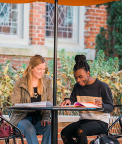 Students studying at a table outside