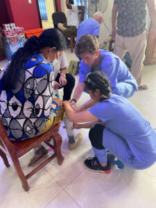 Nyny working with a patient to fit a prosthetic
