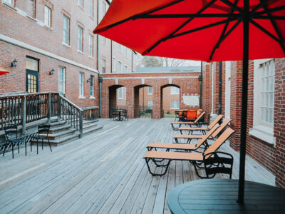 Decking area with loungers between buildings in Mary Erin Porter complex.
