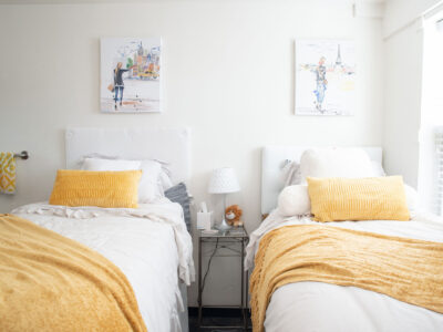 Matching bed sets and wall art in a bedroom in Mary Erin Porter.