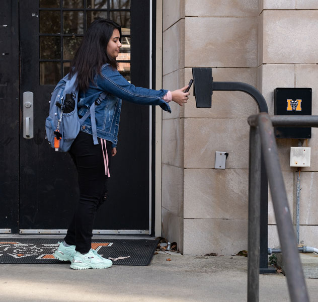 Student using bear card to enter residence hall 