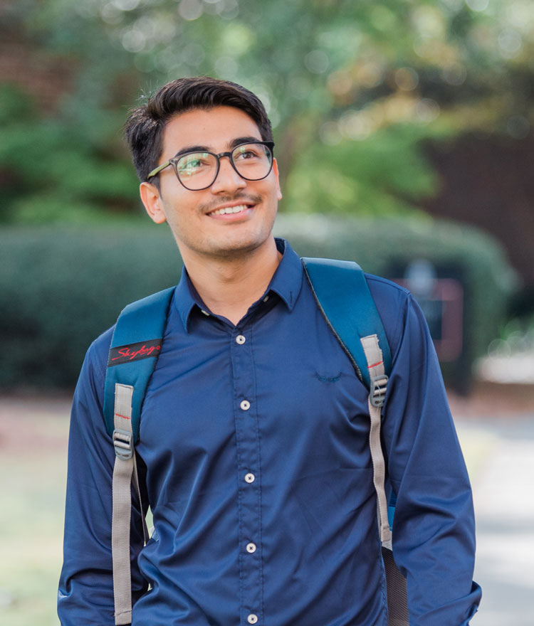 Student with backpack walking on Macon campus