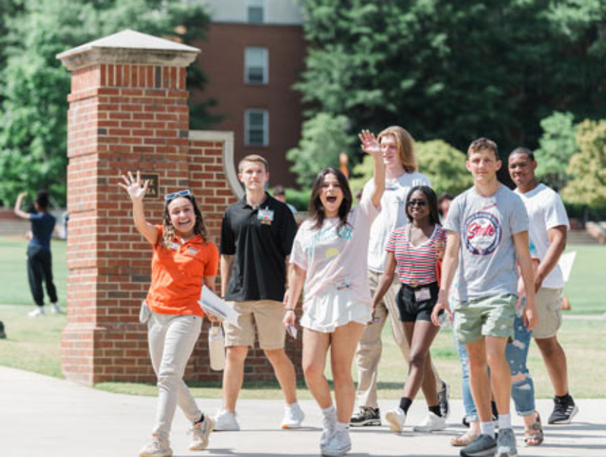 Students waving towards camera