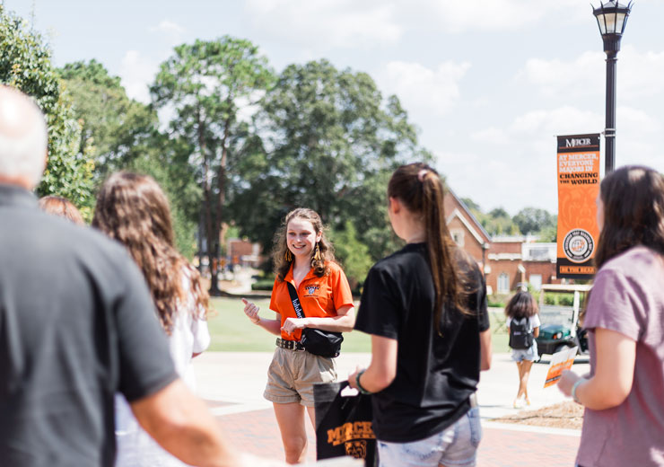 A student giving a tour of campus to guests