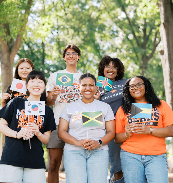 International students standing with country flags outside